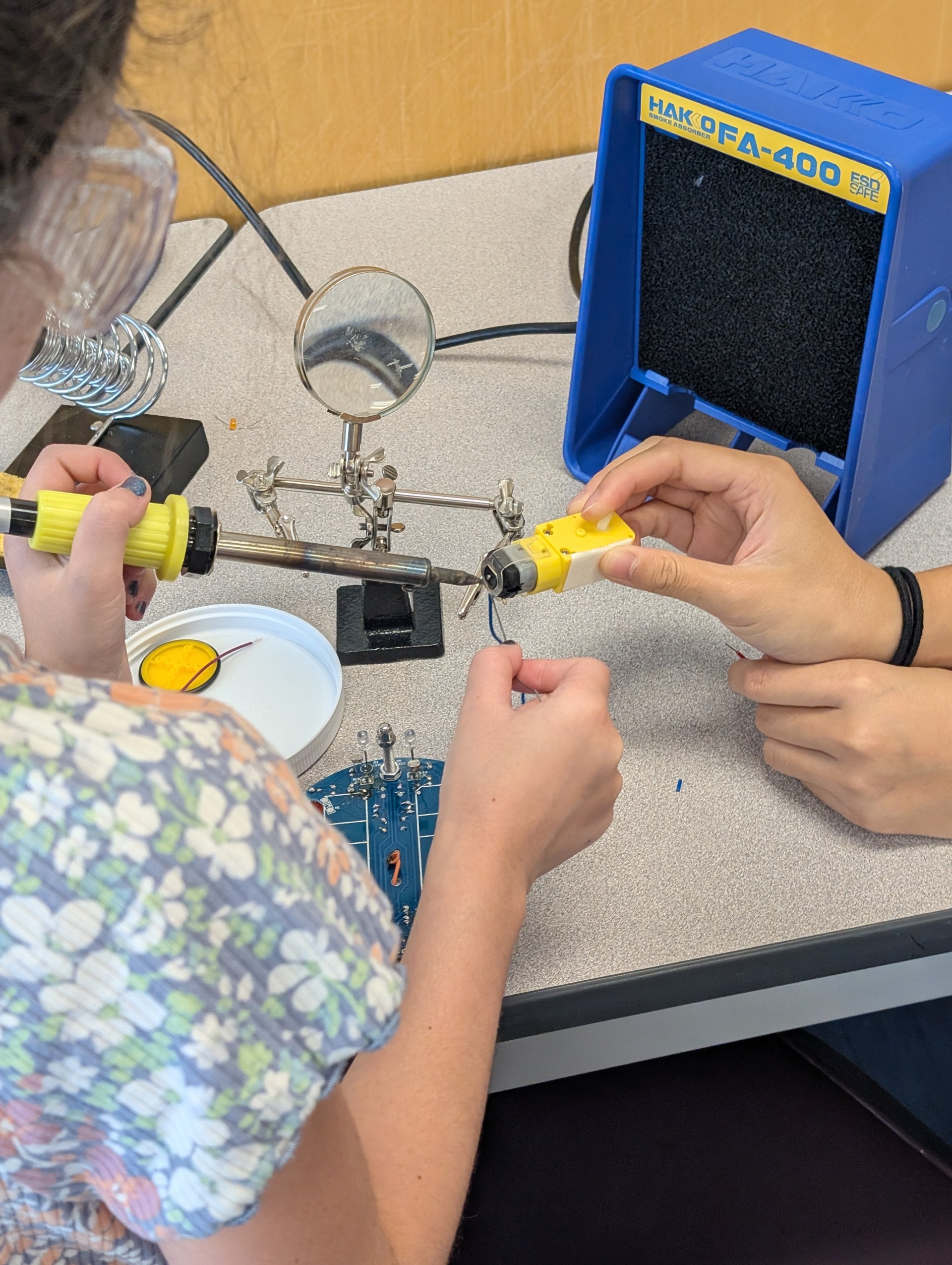 Kids welding electronic parts