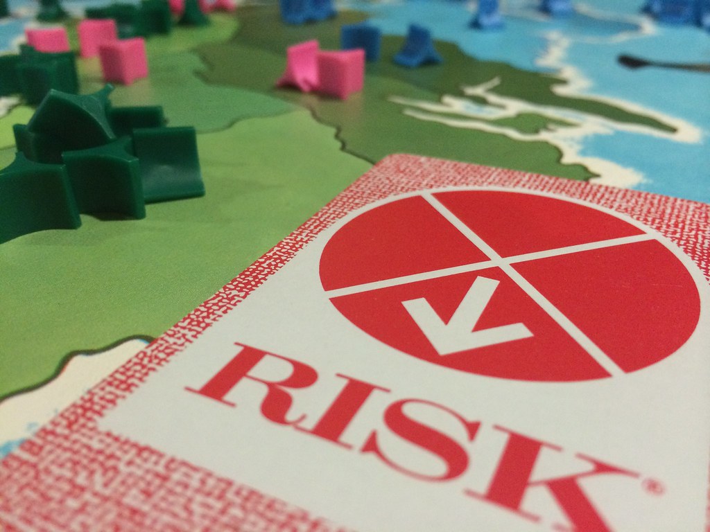 Risk card and game board. Image by Rob Bertholf